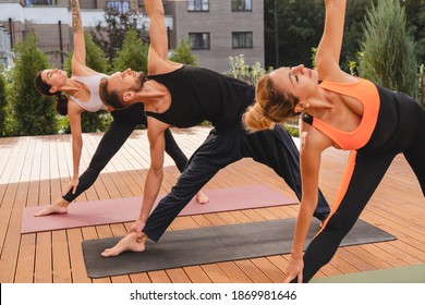 Close Up Shot Of Mature Group Of People Exercising Before Yoga Training Outside In The Garden