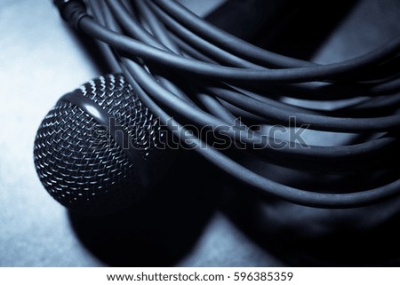 Close up shot of a microphone and some cables.