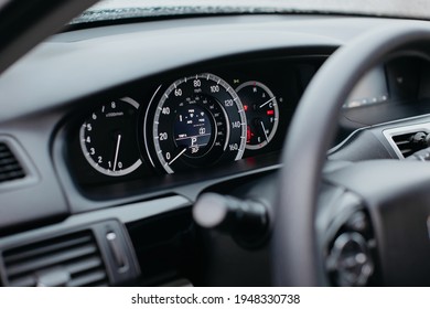 Close up shot of a miles speedometer in a car. Car dashboard. Dashboard details with indication lamps.Car instrument panel. Dashboard with speedometer, tachometer, odometer. 