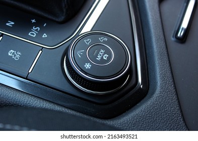 Close up shot of a modern car drive mode selector button, on the central console. Drive Mode Select.  Drive selector button. Modern Car interior, offroad drive controller closeup view. Esp off.
