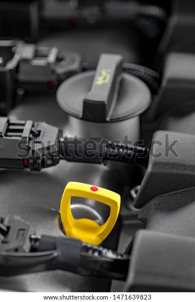Close up shot of modern car motor oil dipstick and\
oil change cap
