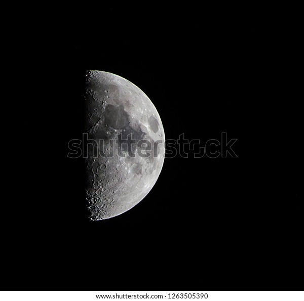 Close up\
shot of the moon during first quarter\
phase