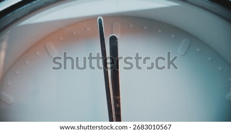 Close Up Shot of Moving Clock Hands Showing Precise Time on Minimalist White Wall Clock. Contemporary Design Element of Interior in Warm Light. Concept of Time Management, Punctuality and Lifestyle.