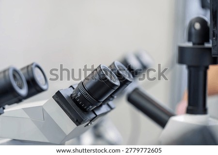 Close up shot of multi eyepiece microscope in laboratory