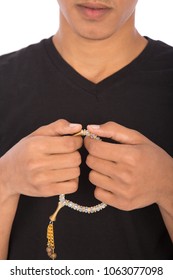 Close shot of a Muslim boy holding  a rosary and doing zikr, isolated on white background