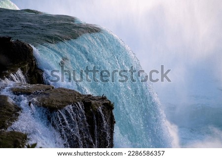 Close up shot of Niagara River - water flowing down the rocks in Niagara Falls, New York, USA