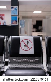 Close Up Shot Of Not Sitting Poster Glued To Chair Back Inside Hospital Corridor. Seat Marked Preventing Use At Empty Doctor Office. Clinic Waiting Chair Vertical Detail.