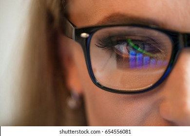 Close up shot og glasses with the reflection of graphics in it. - Shutterstock ID 654556081