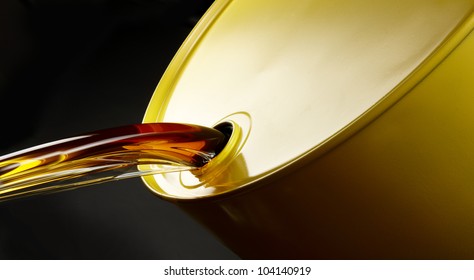 Close up shot of oil pouring out of yellow barrel