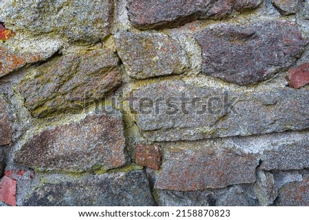 A close up shot of the old cracked stone wall background 