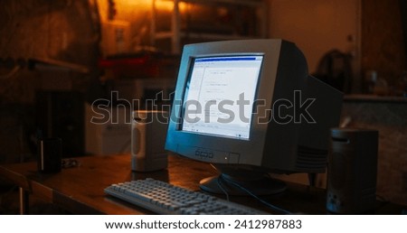 Close Up Shot Of Old Desktop Computer On Work Desk Of Software Developer In Retro Garage. Dated PC Has Operating System Terminal Opened, Prompts Running On Screen, Code Functioning Successfully.