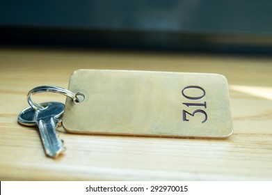 Close Up Shot Of Old Hotel Room Key Shot On Wood Front Desk