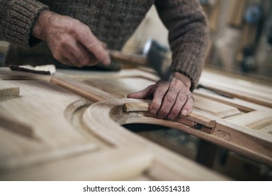 Close up shot of old master carpenter working in his woodwork or workshop - Powered by Shutterstock