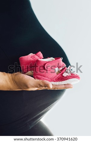 Similar – Image, Stock Photo Baby sneakers held by pregnant