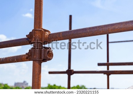 Close up shot on joint of steel rusty scaffold placed on construction site.