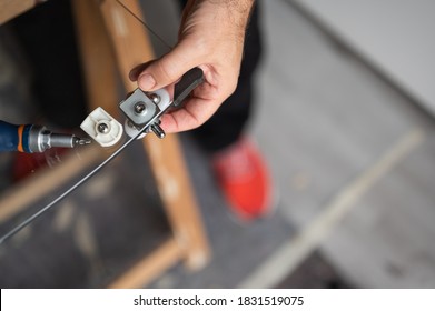 Close up shot on the shower stall trolley during its installation on the glass door. The Caucasian man's hand holds it in place in its seat. - Shutterstock ID 1831519075