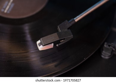 Close Up Shot On Turntable Arm Hovering Above Record