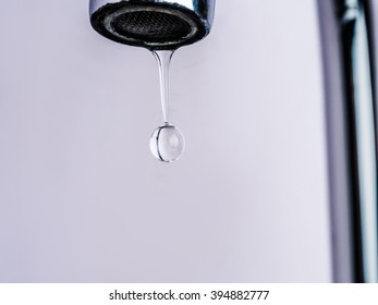 Close Up Shot On Water Drop From Faucet In Stop Motion