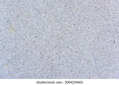 The close up shot of pale white exposed aggregate finish wall surface of building and swimming pool for creating friction and slippery prevention