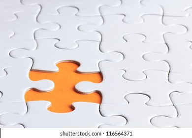 close up shot of plain puzzle with a missing piece