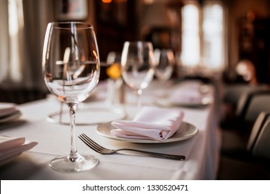 A Close Up Shot Of A Restaurant Table Set Up With Tableware And Wine Glass. Concept Of Dining, Hospitality And Catering. Horizontal Image With Free Space For Text. 