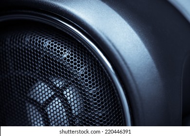 Close up shot of a round speaker in a car.