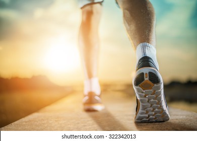 Close Up Shot Of Runner's Shoes.A Person Running Outdoors On A Sunny Day. Only The Feet Are Visible. The Person Is Wearing Black Running Shoes.Exercise, Fitness And Healthy Lifestyle.