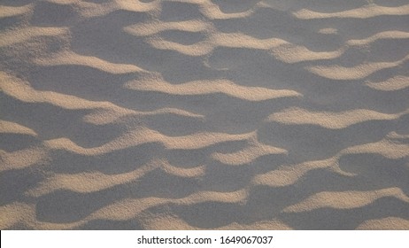 Close up shot of sand shaped by wind