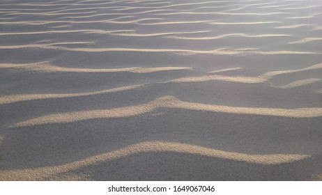 Close up shot of sand shaped by wind
