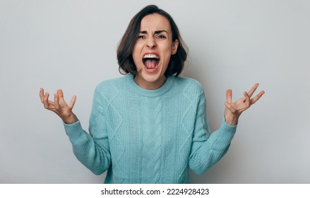Close up shot of screaming crazy frustrated woman with anxiety, anger and depression. Very upset and emotional woman crying. Young girl with angry and furious face. Human expressions and emotions - Shutterstock ID 2224928423