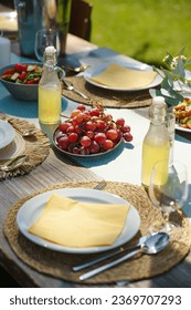 Close up shot of a set table at a summer garden party.