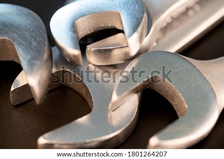 Close up shot of several spanner wrenches on a blackk background