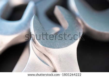 Close up shot of several spanner wrenches on a blackk background