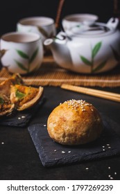 Close Up Shot Of Shanghai Mooncake With Chinese Tea Set At The Back