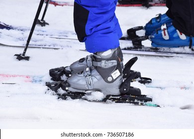 Close Up Shot Of Ski Boots And Skis Waiting In Line