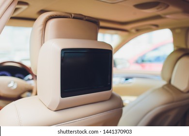 Close Up Shot Of A Small Screen Dvd Player Inside A Car.