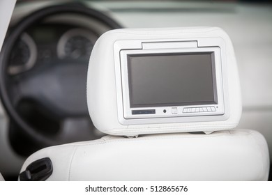 Close Up Shot Of A Small Screen Dvd Player Inside A Car.