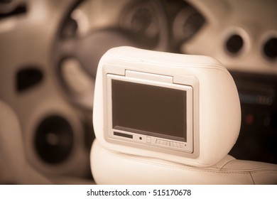 Close Up Shot Of A Small Screen Dvd Player Inside A Car.