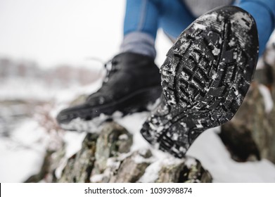 Close Up shot of sole of the trekking boot with snow