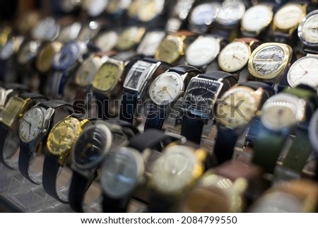 Close up shot of some vintage watches on display in a shop.