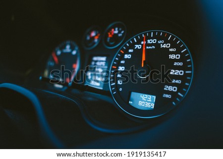 Close up shot of a speedometer in a car. Car dashboard with details with indication lamps and instrument panel. Modern interior.