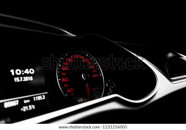 Close up shot of a speedometer in a car. Car\
dashboard. Dashboard details with indication lamps.Car instrument\
panel. Dashboard with speedometer, tachometer, odometer. Car\
detailing. Black and\
white