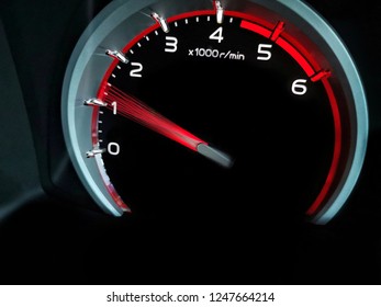 Close up shot of a speedometer in a car.   At an engine speed of 1500 rpm on  Car dashboard.Car Interior ilumination.