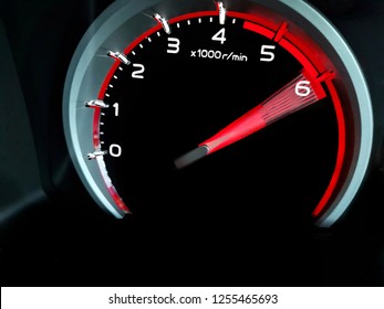 Close up shot of a speedometer in a car. At an engine speed of  6000 rpm on Car dashboard.Car Interior ilumination.
