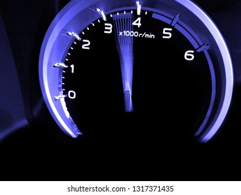 Close up shot of a speedometer in a car. At an engine speed of 3000 to​ 4000​ rpm on Car dashboard.Car Interior ilumination. 