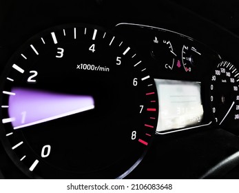 Close up shot of a speedometer in a car. At an engine speed of 800​ to​ 1500 rpm on Car dashboard.Car Interior ilumination.