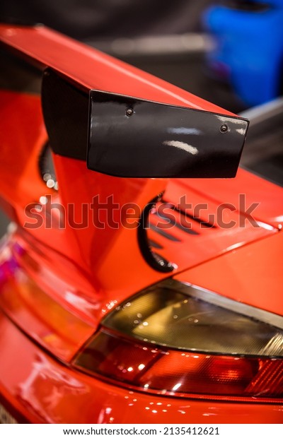 Close up\
shot of a sports car spoiler at the\
rear.