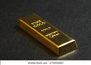 Close Up Shot Of Stacked 999.9 Pure Gold Bar Ingot On A Black Background, Represented The Business, Invesment And Finance Concept Idea