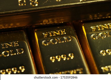 Close Up Shot Of Stacked 999.9 Pure Gold Bar Ingot On A Black Background, Represented The Business, Invesment And Finance Concept Idea