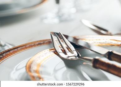 Close Up Shot Of Table Setting For Fine Dining With Cutlery And Glassware